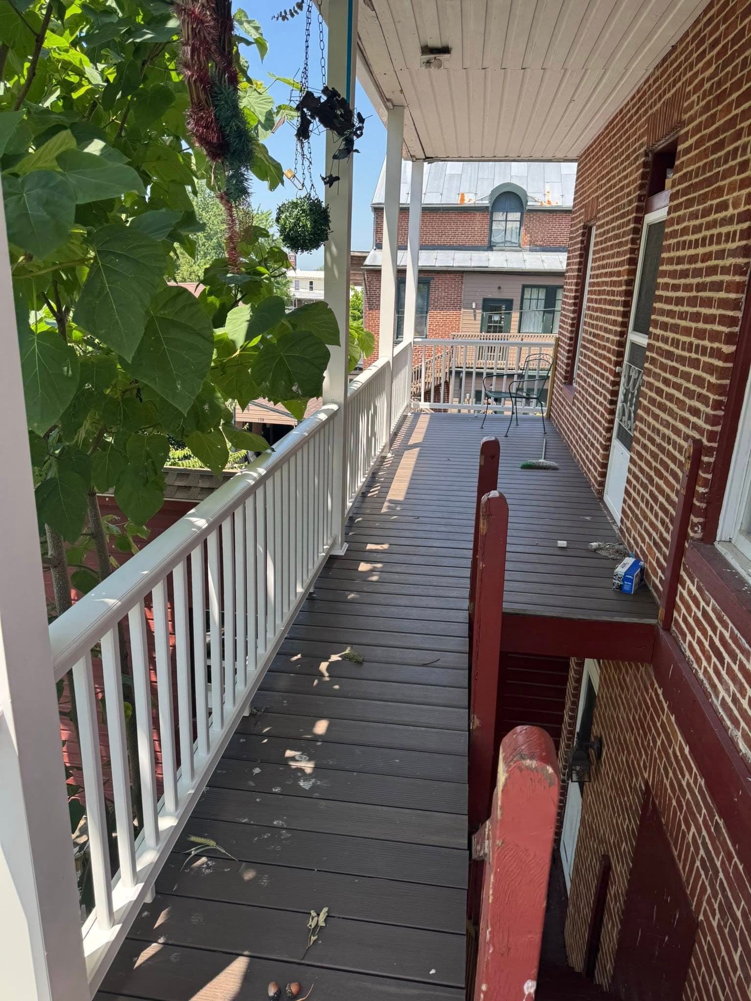 Second story porch with new composite decking and white railing