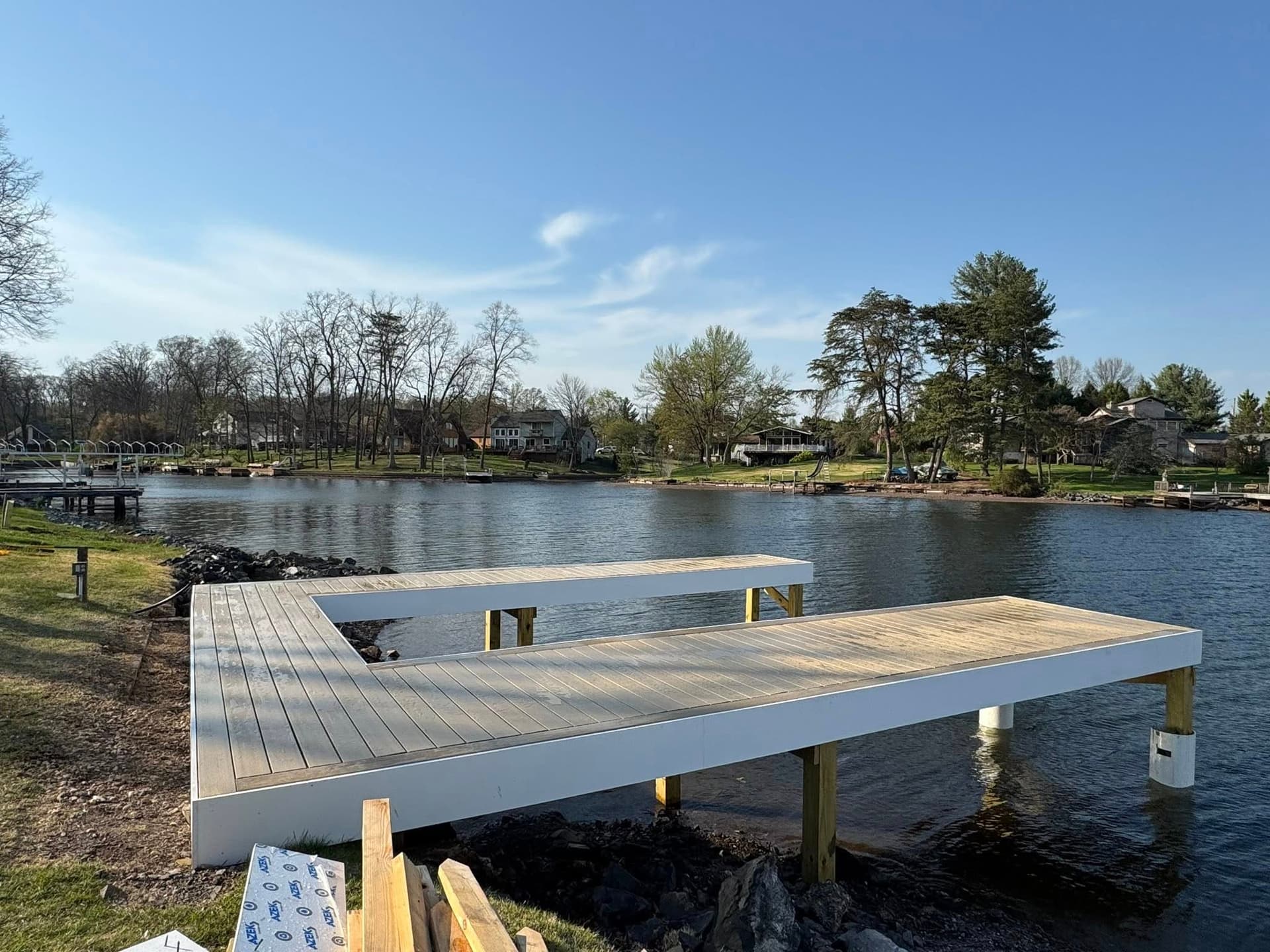 Side view of completed dock with composite boards on a clear spring day