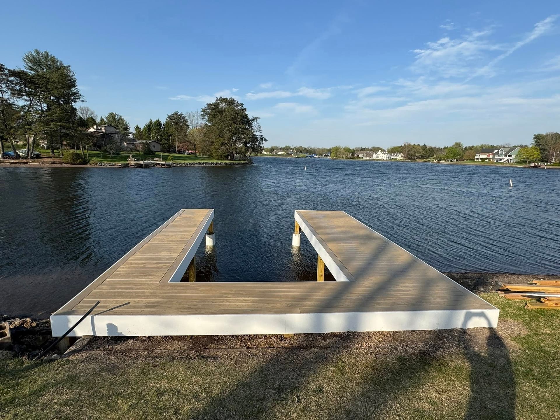 Finished U-shaped lakeside dock with composite decking and white trim