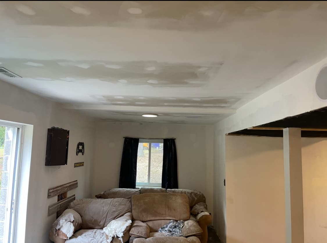 Living room ceiling with fresh drywall and finished seams