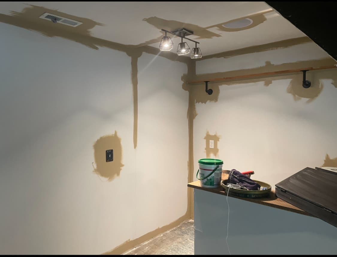 Basement walls with drywall compound applied over patched seams