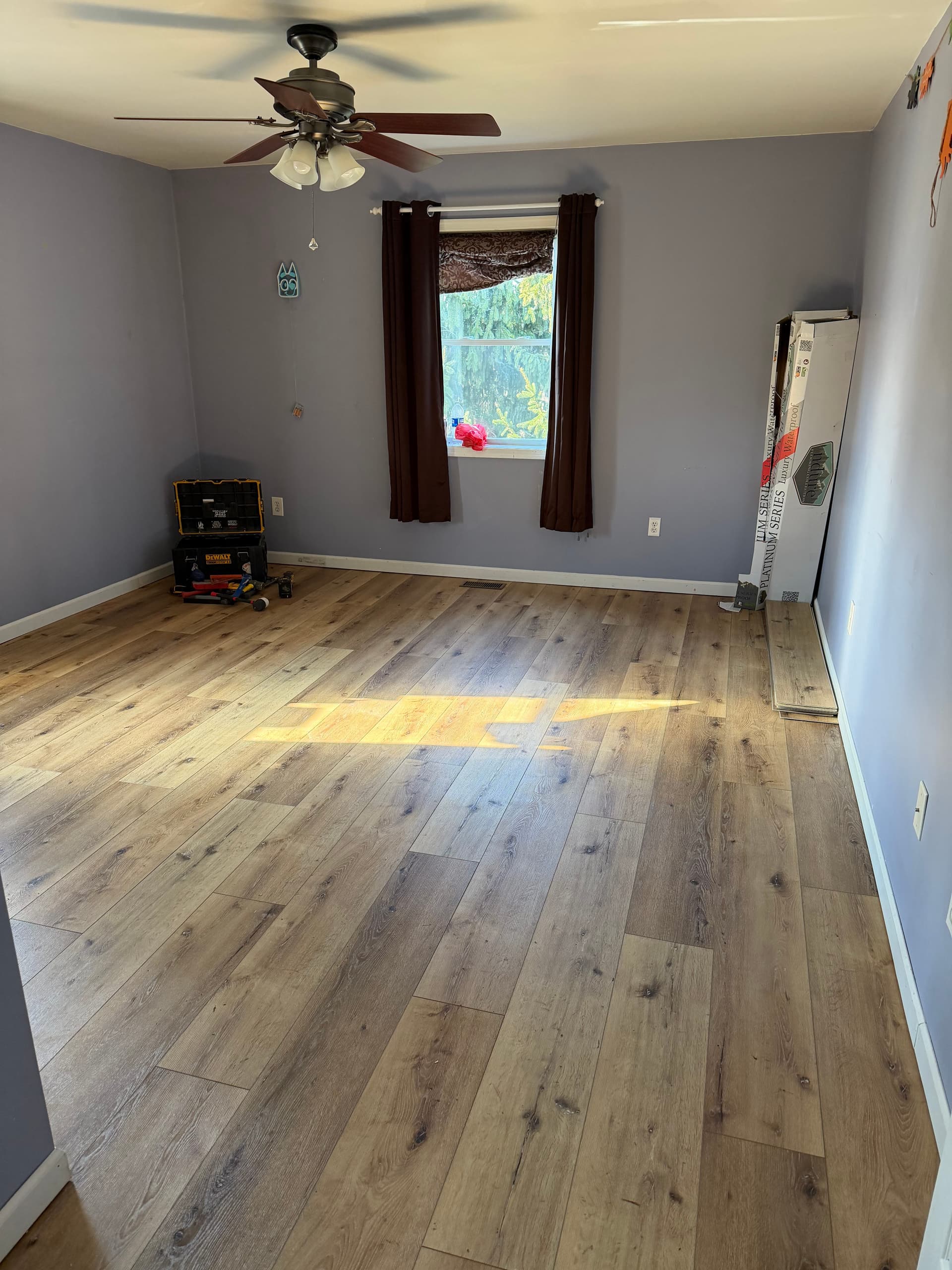 Bedroom with new luxury vinyl plank flooring installed wall to wall