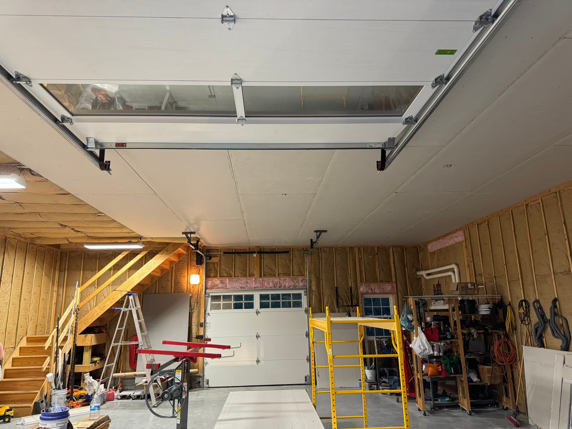 Same garage after drywall installation on the ceiling