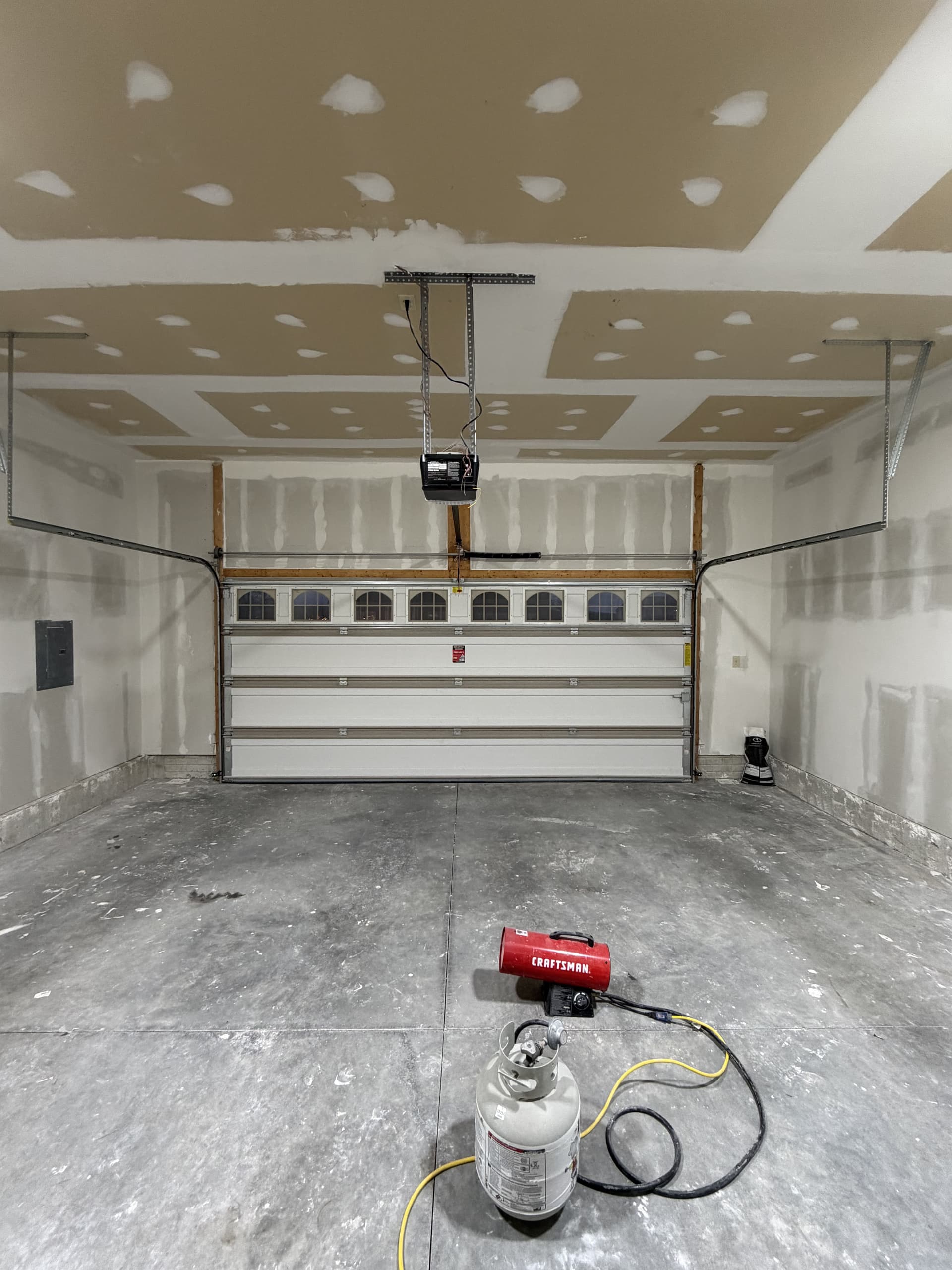 Two-car garage with newly hung and mudded drywall ceiling