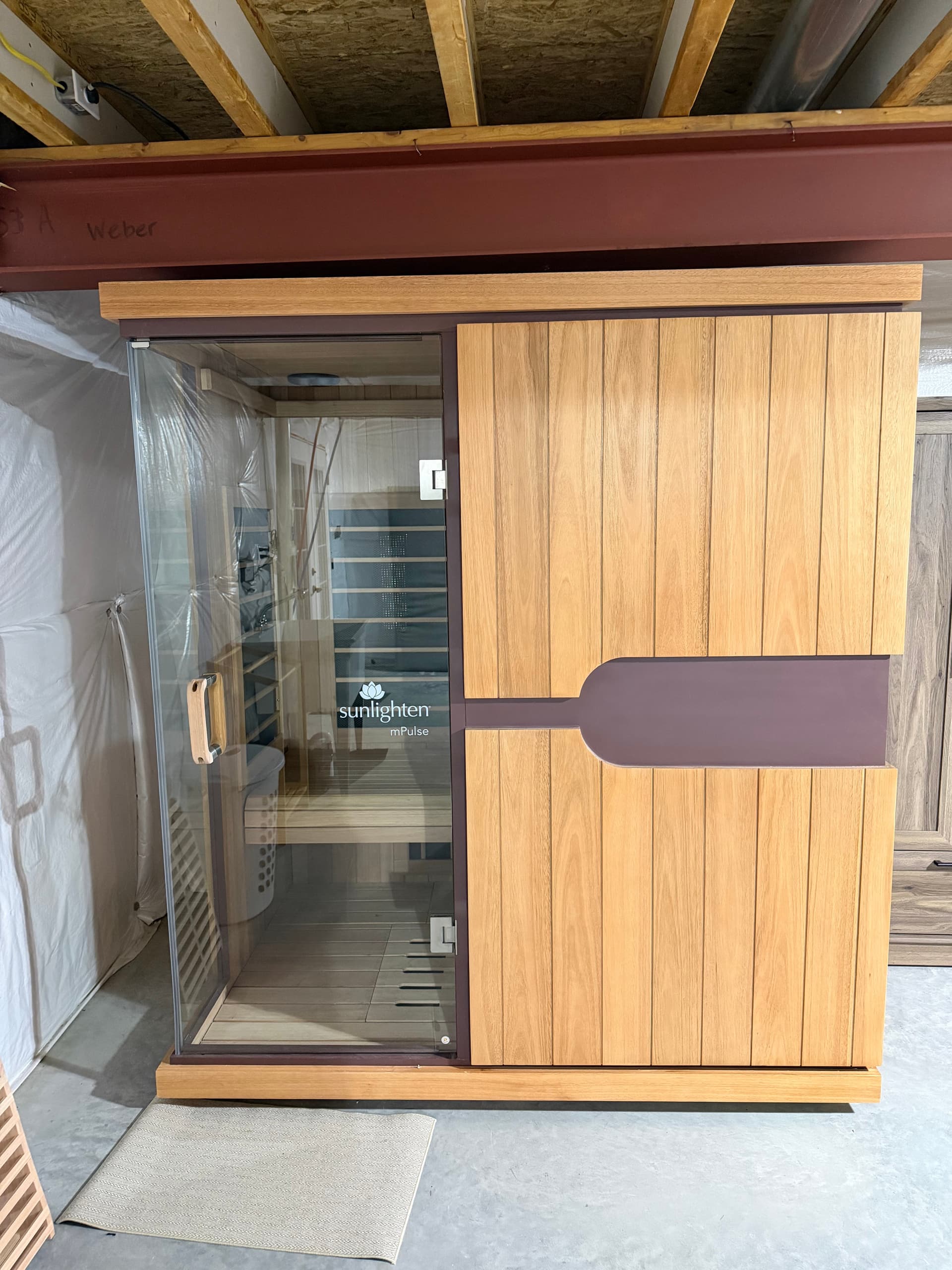 Infrared sauna cabin installed in a finished basement space